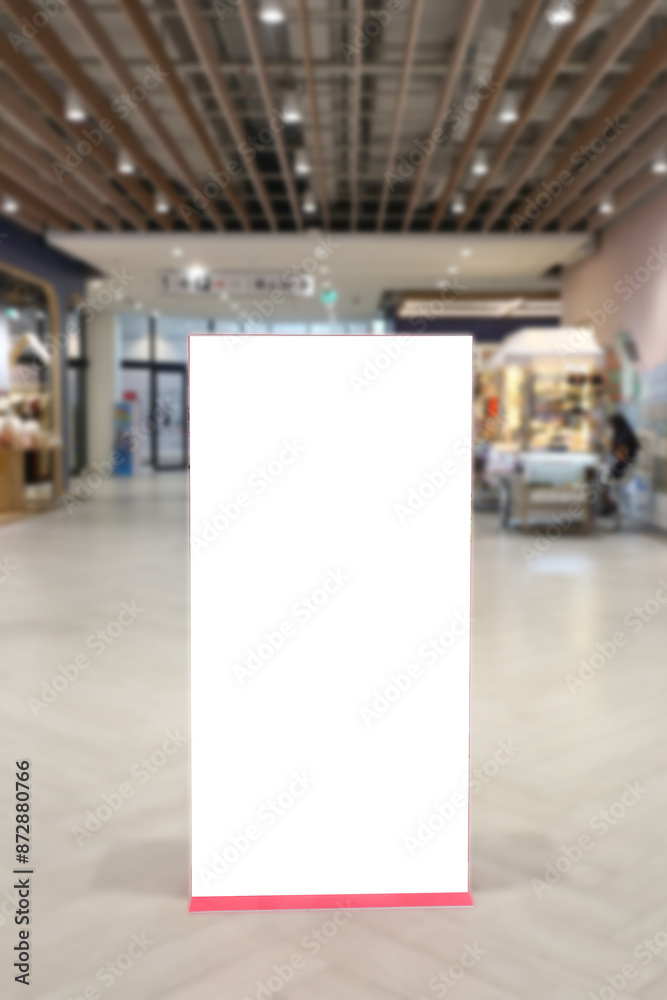 A blank billboard stands in a shopping mall. A blank billboard stands in a shopping mall.