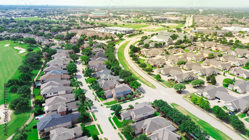Golf course residential neighborhood along suburban street with gated community for active senior adults in upscale West Plano, Texas, condominium duplex maintenance-free lifestyle, aerial view