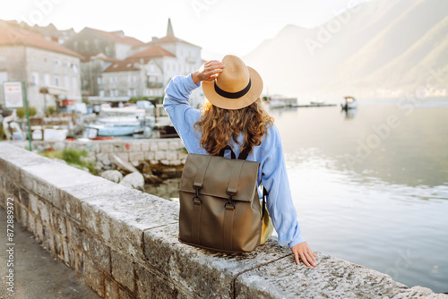Photos Back view of Tourist woman on the observation deck admiring view of colorful the view of the city and gulf