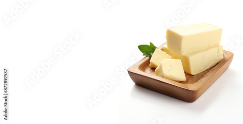 fresh butter block on wooden bowl on white background