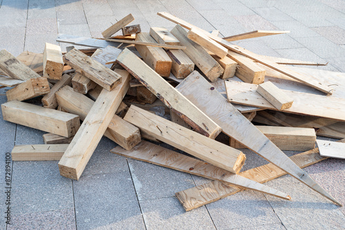 A pile of construction debris made of wooden planks. Boards after disassembly of the formwork for construction