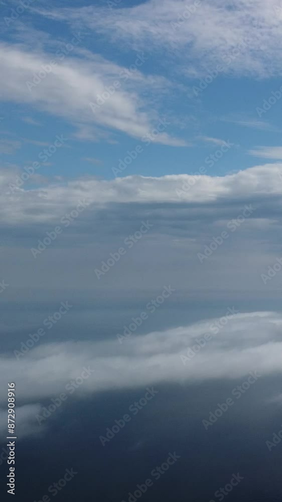 Aerial view. Blue sky sun and fog over calm sea. The drone flies over foggy and fluffy clouds. Abstract aerial nature summer ocean sunset sea and sky background. Vacation, travel and holiday concept. Aerial view. Blue sky sun and fog over calm sea. The drone flies over foggy and fluffy clouds. Abstract aerial nature summer ocean sunset sea and sky background. Vacation, travel and holiday concept.