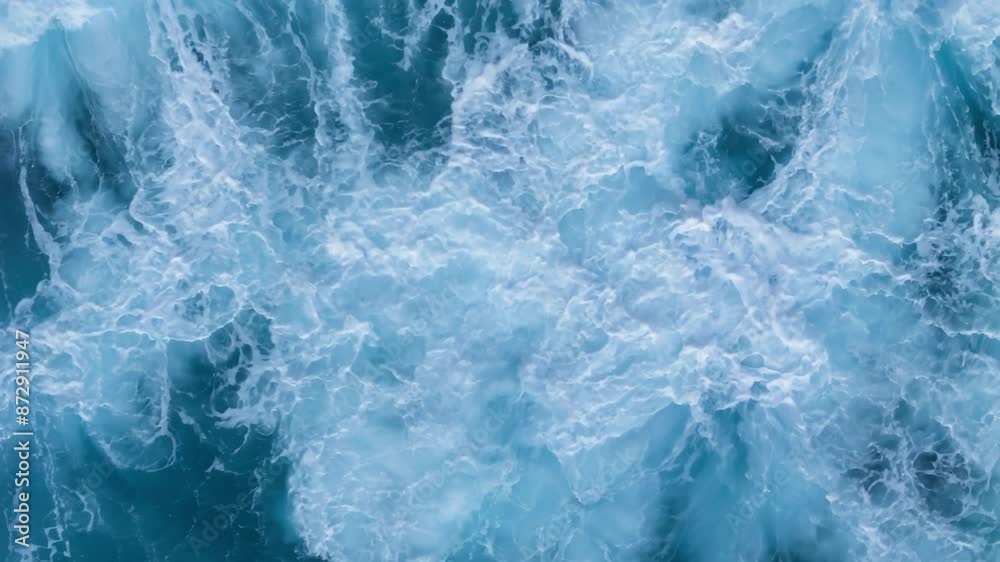 Aerial top down view of oceanic tidal waves rolling and creating foam patterns, Above Natural Water Swirl Wind Day