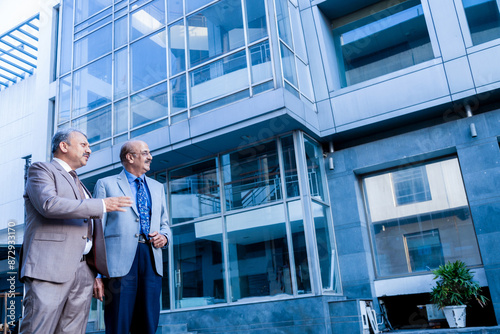 Wallpaper Mural two senior indian business person looking at modern, corporate glass office. success, growth and workplace concept. Torontodigital.ca