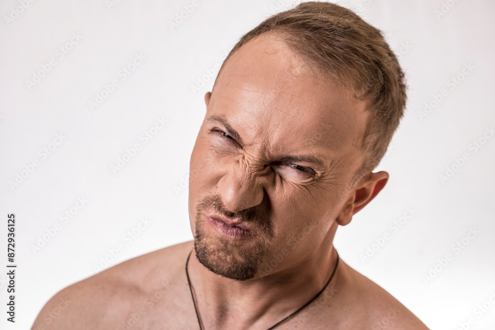 Fototapeta premium Strong man face. Portrait of a smiling handsome young man