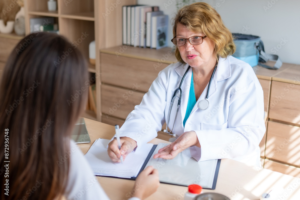 Teen Girl Giving Interview to Social Worker or Psychologist During Counseling Session for Depression and Therapy Teen Girl Giving Interview to Social Worker or Psychologist During Counseling Session for Depression and Therapy