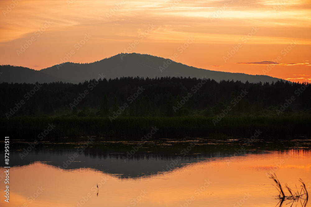 Obraz premium evening view of mountains covered with forest, beautiful sunset