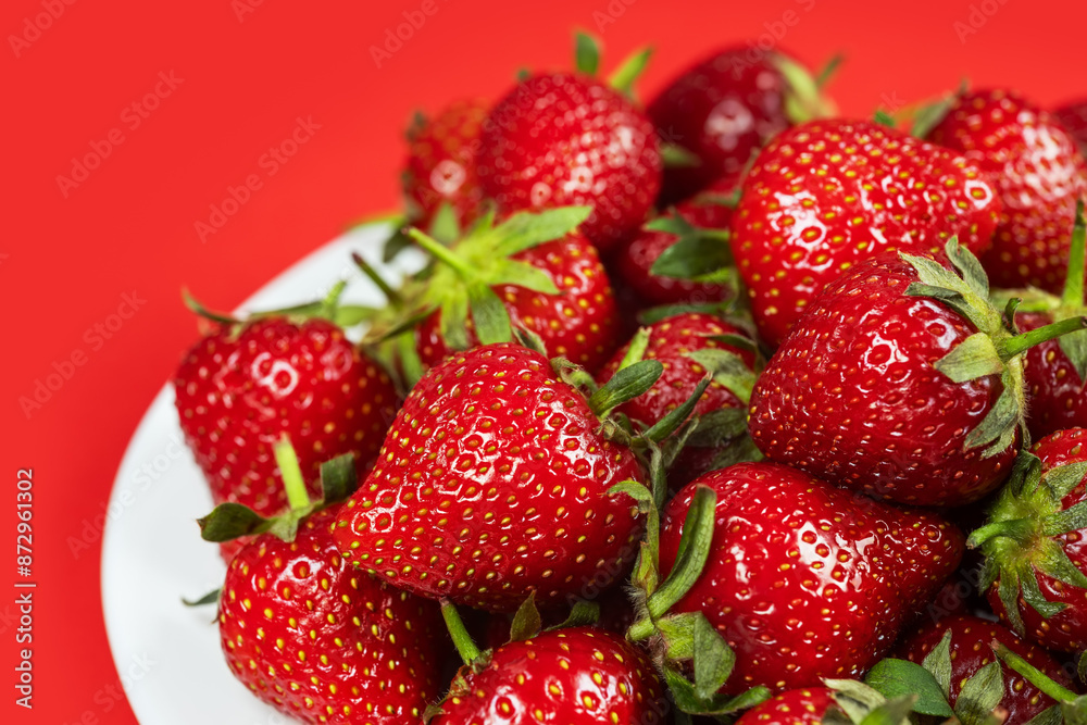Fresh ripe perfect strawberry on red background Fresh ripe perfect strawberry on red background