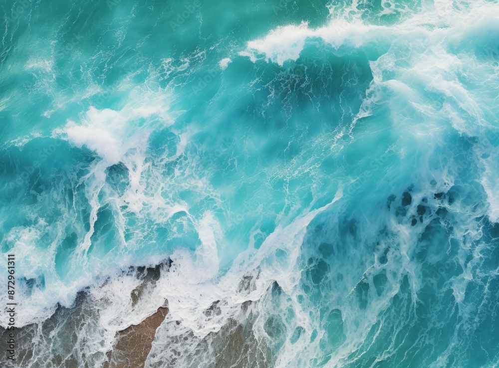 A close-up view of a large ocean wave crashing against the shore, creating a plume of white foam. A close-up view of a large ocean wave crashing against the shore, creating a plume of white foam.