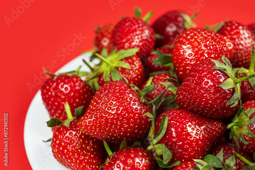 Fresh ripe perfect strawberry on red background