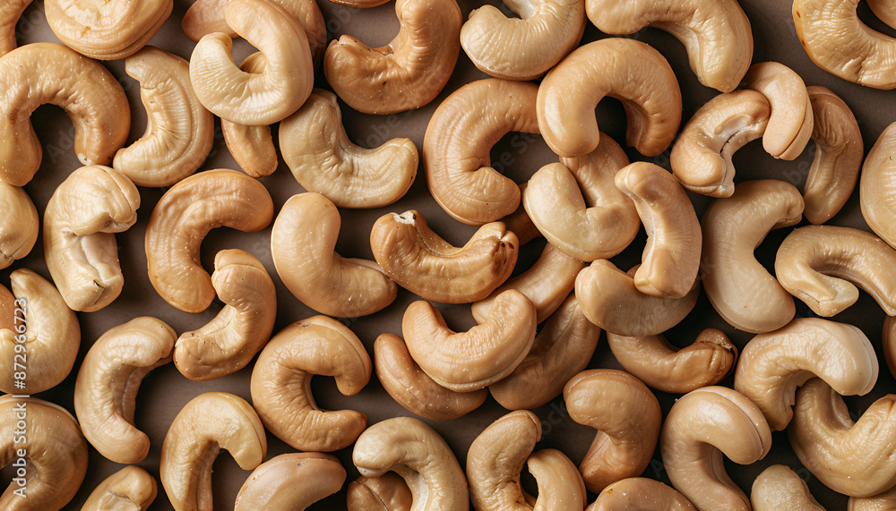 Many tasty cashew nuts as background, top view Many tasty cashew nuts as background, top view