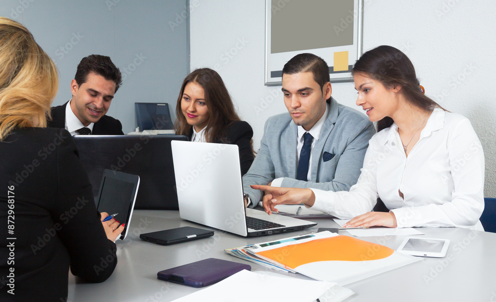 Students at negotiations in a conference room with their teacher Students at negotiations in a conference room with their teacher