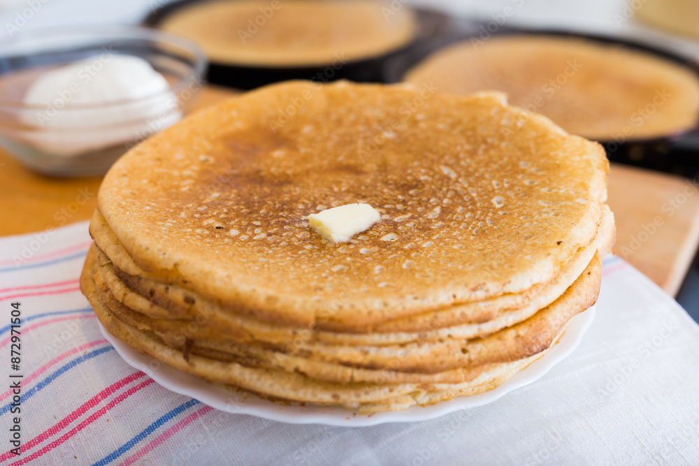 stack of appetizing flour pancakes in the kitchen during cooking stack of appetizing flour pancakes in the kitchen during cooking