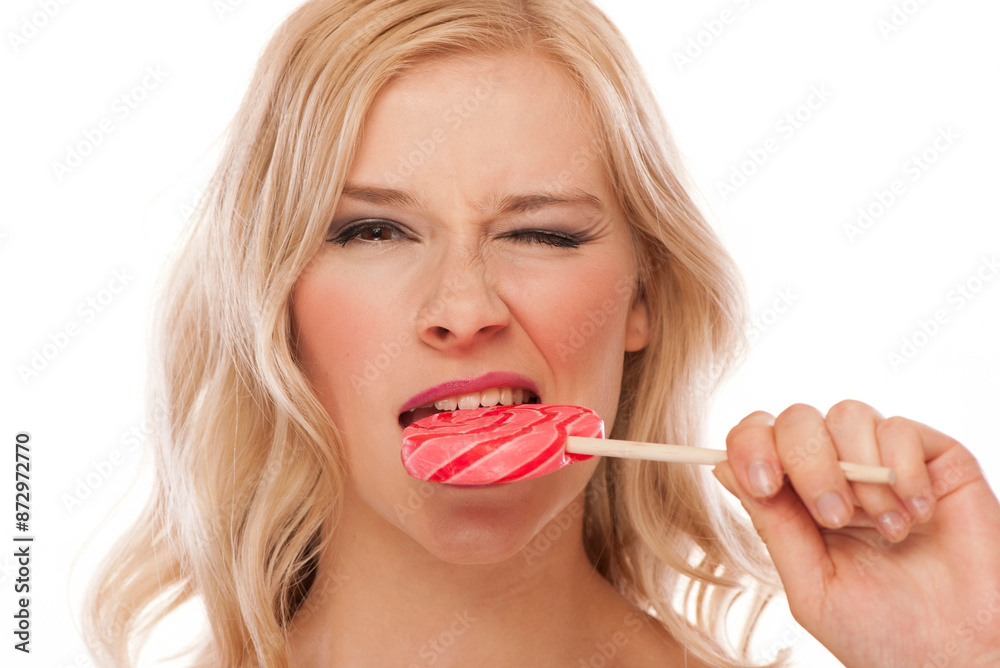 pretty blonde woman biting a lollypop pretty blonde woman biting a lollypop