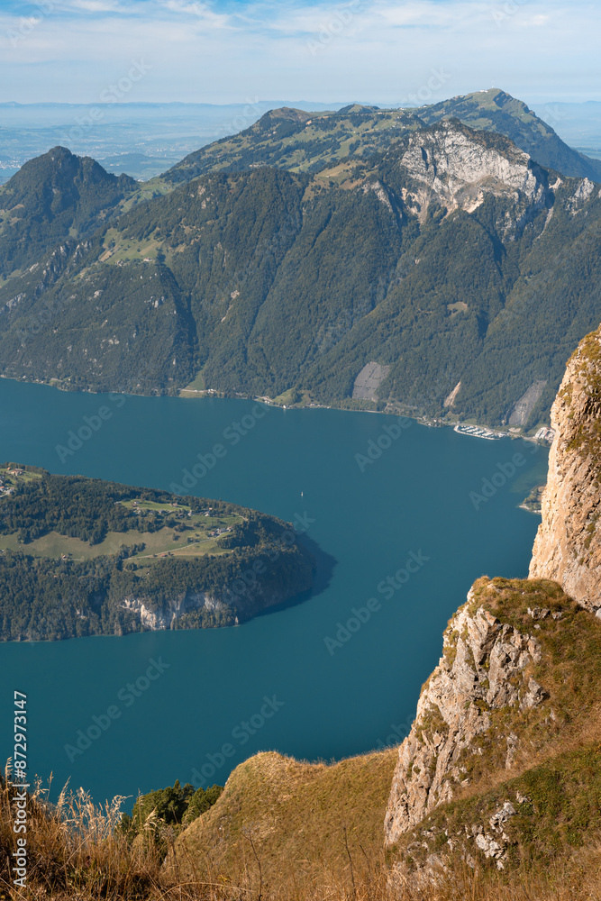 Lake in a valley seen from Fronalpstock summit in Switzerland. Swiss Alps iconic view