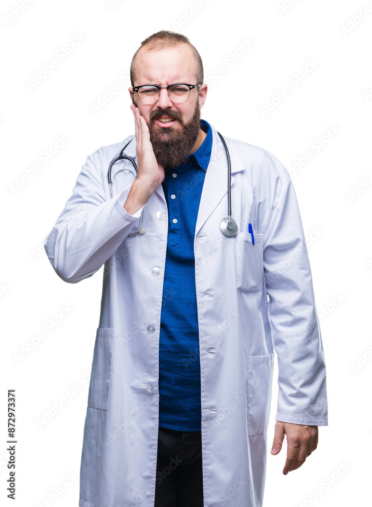 Young caucasian doctor man wearing medical white coat over isolated background touching mouth with hand with painful expression because of toothache or dental illness on teeth. Dentist concept.