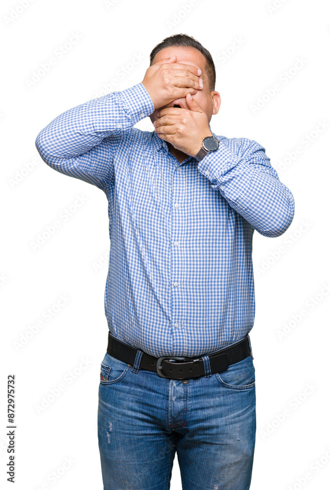 Middle age arab business man over isolated background Covering eyes and mouth with hands, surprised and shocked. Hiding emotion Middle age arab business man over isolated background Covering eyes and mouth with hands, surprised and shocked. Hiding emotion