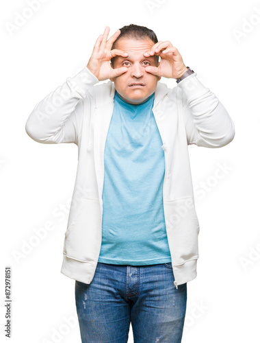 Middle age arab man wearing sweatshirt over isolated background Trying to open eyes with fingers, sleepy and tired for morning fatigue