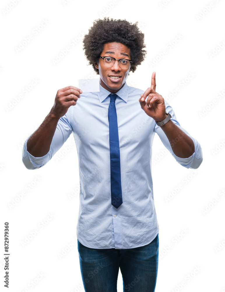 Afro american man holding visit card over isolated background surprised with an idea or question pointing finger with happy face, number one Afro american man holding visit card over isolated background surprised with an idea or question pointing finger with happy face, number one