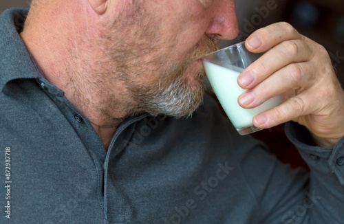 The man drinks a fresh milk.