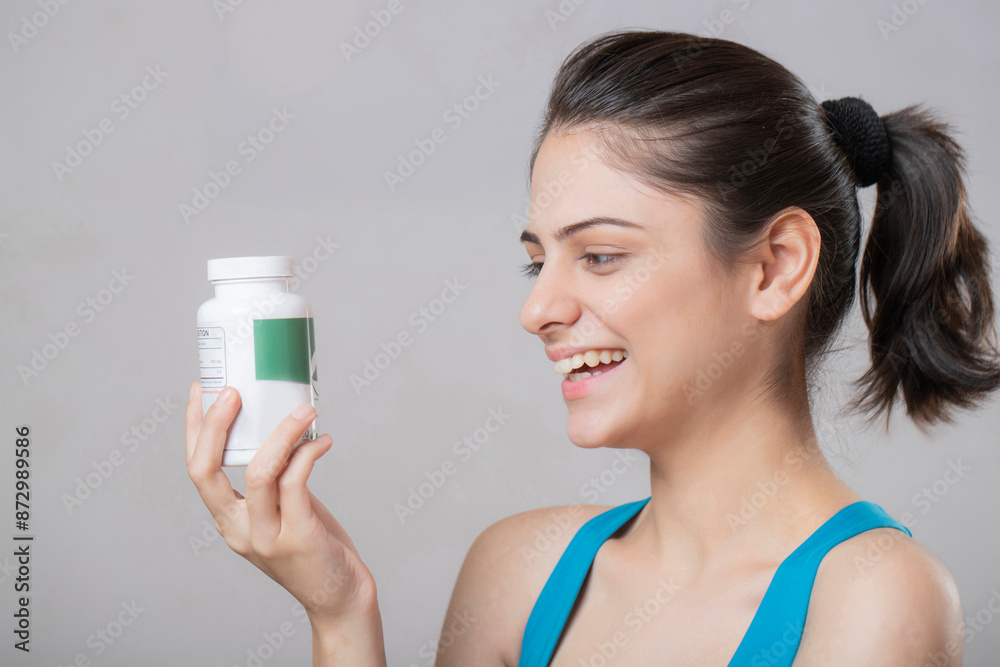 Gorgeous Blonde Woman Posing Sideways With A Medicine Bottle Gorgeous Blonde Woman Posing Sideways With A Medicine Bottle