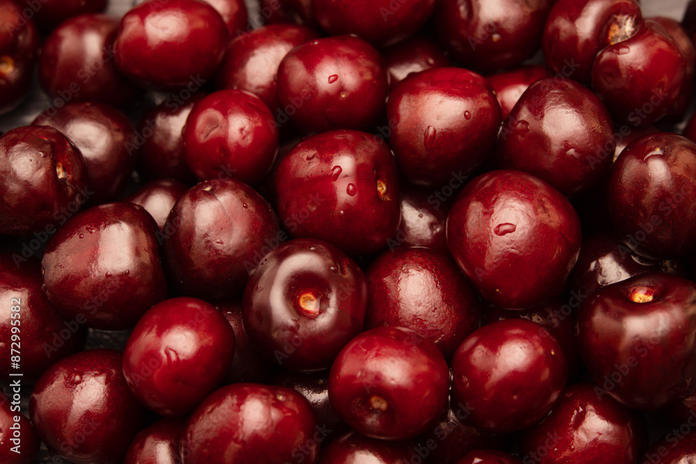 juicy, delicious cherries in a splash of water on a dark background. juicy, delicious cherries in a splash of water on a dark background.