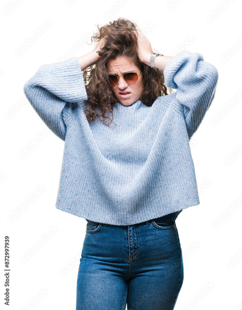 Beautiful brunette curly hair young girl wearing sunglasses over isolated background suffering from headache desperate and stressed because pain and migraine. Hands on head.