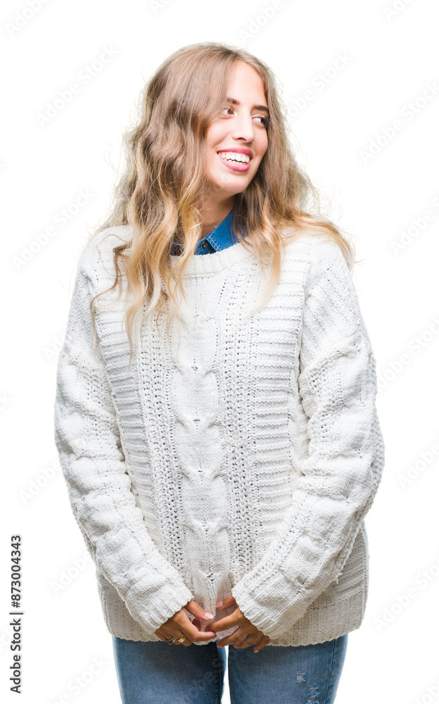 Beautiful young blonde woman wearing winter sweater over isolated background looking away to side with smile on face, natural expression. Laughing confident. Beautiful young blonde woman wearing winter sweater over isolated background looking away to side with smile on face, natural expression. Laughing confident.