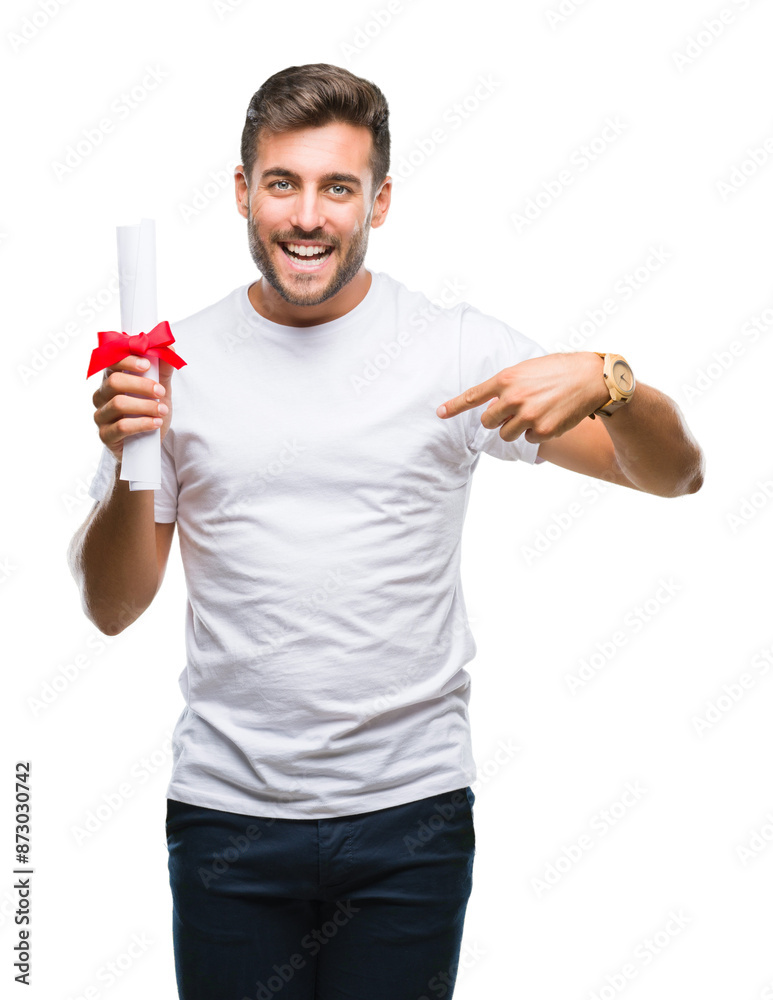 Young handsome man holding degree over isolated background with surprise face pointing finger to himself Young handsome man holding degree over isolated background with surprise face pointing finger to himself