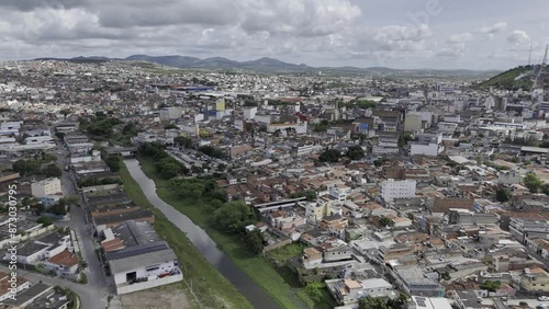 Drone flies along Ipojuca River toward Monte Bom Jesus in Caruaru, Pernambuco, Brazil photo