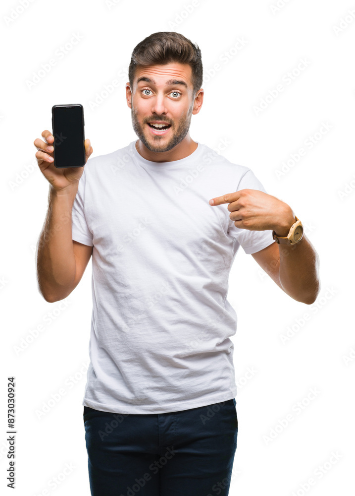 Young handsome man showing smartphone screen over isolated background with surprise face pointing finger to himself Young handsome man showing smartphone screen over isolated background with surprise face pointing finger to himself