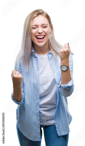 Young blonde woman over isolated background very happy and excited doing winner gesture with arms raised, smiling and screaming for success. Celebration concept.