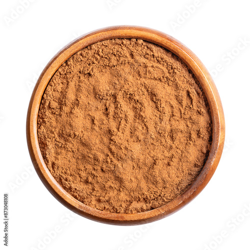 Cassia cinnamon powder in a wooden bowl. Ground raw bark of Chinese cinnamon, also known as Chinese cassia, Cinnamomum cassia. Used as aromatic condiment and flavouring additive in a wide variety.