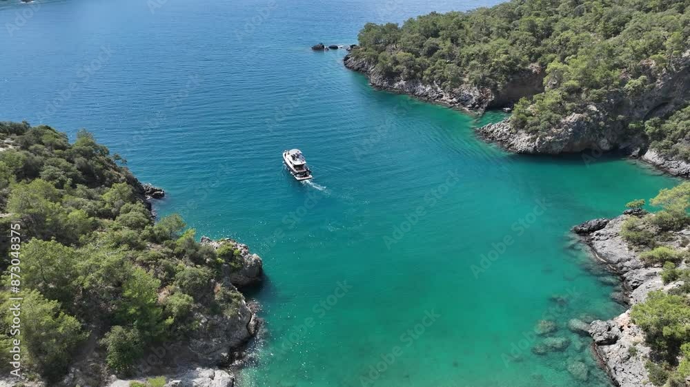 Drone filming a beautiful super luxurious motor yacht sailing during summer season.