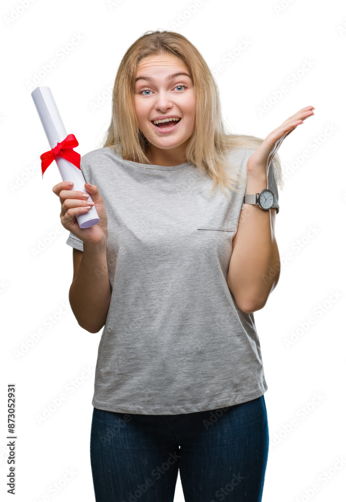 Young caucasian woman holding degree over isolated background very happy and excited, winner expression celebrating victory screaming with big smile and raised hands