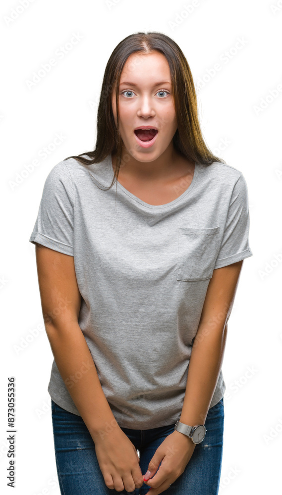 Fototapeta premium Young caucasian beautiful woman over isolated background afraid and shocked with surprise expression, fear and excited face.
