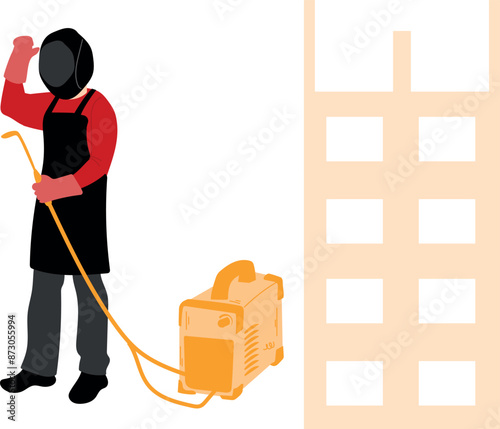 A worker stands next to a welding machine.