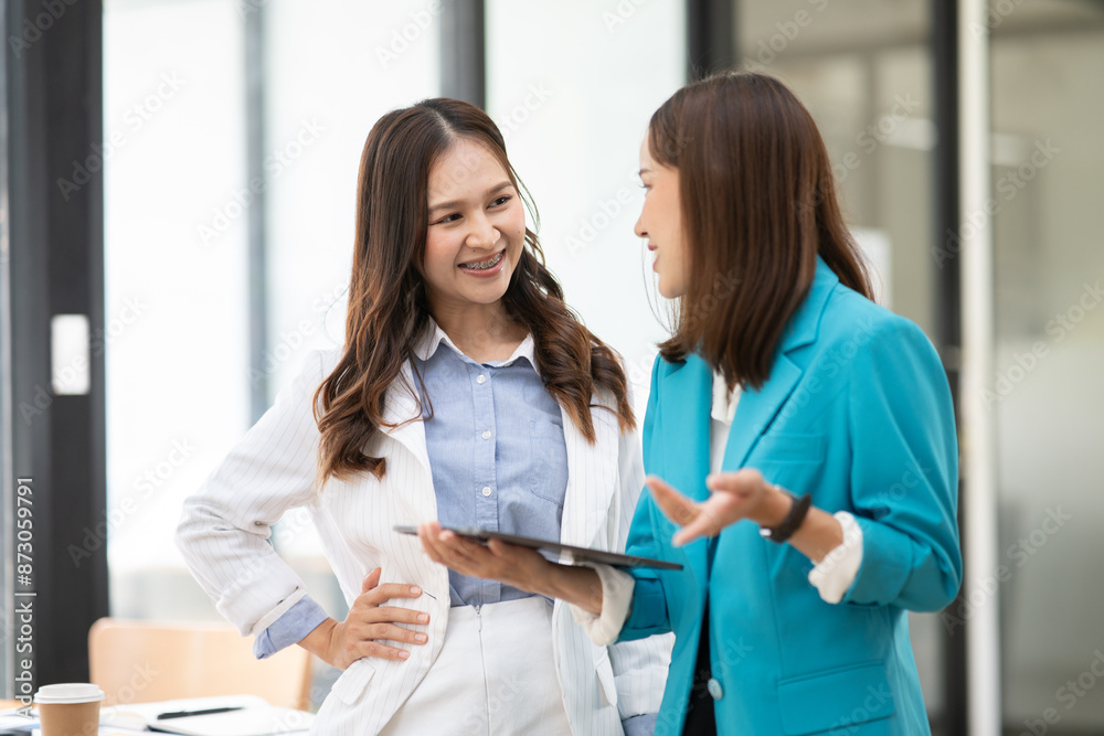 Business women Discuss and plan work on graph documents at the office. Business women Discuss and plan work on graph documents at the office.