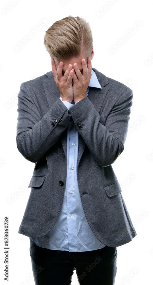 Young handsome blond business man with sad expression covering face with hands while crying. Depression concept. Young handsome blond business man with sad expression covering face with hands while crying. Depression concept.