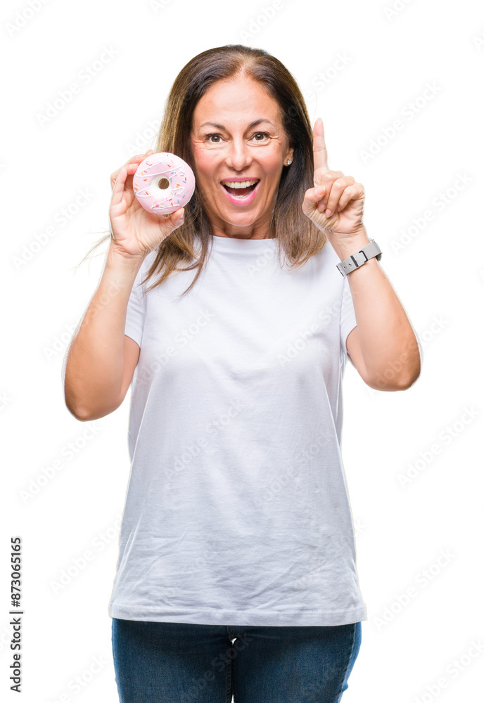 Middle age hispanic woman eating pink donut over isolated background surprised with an idea or question pointing finger with happy face, number one Middle age hispanic woman eating pink donut over isolated background surprised with an idea or question pointing finger with happy face, number one