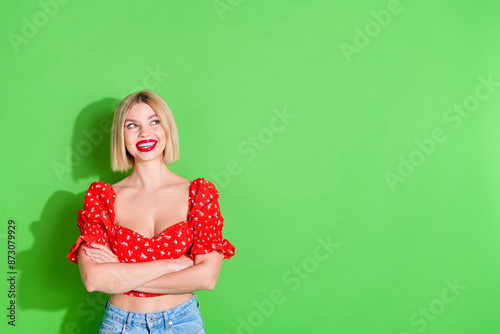 Photo of smiling happy girl cross arms look empty space isolated green color background
