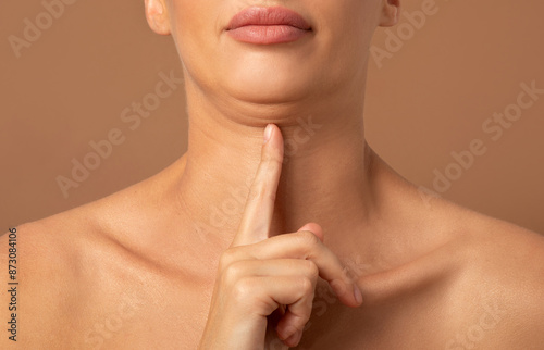 Closeup of woman showing second chin, problems with excess weight, demonstrating her cosmetic problem, need facial line correction