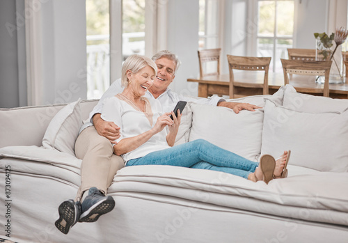Senior couple, smile and phone on sofa for social network, funny gif and healthy marriage with love in home. Happy, mature woman and man with mobile for retirement, online and bonding together © peopleimages.com