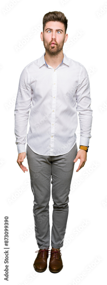 Young handsome business man making fish face with lips, crazy and comical gesture. Funny expression.