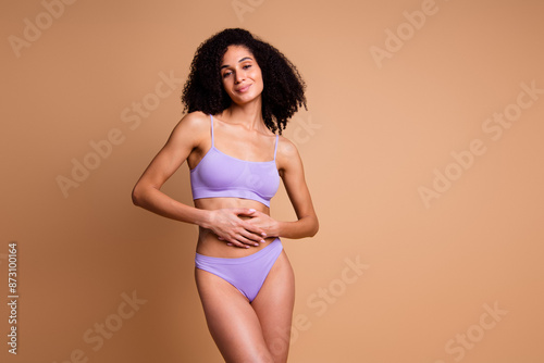 No filter portrait of stunning model girl hands touch belly empty space isolated on beige color background