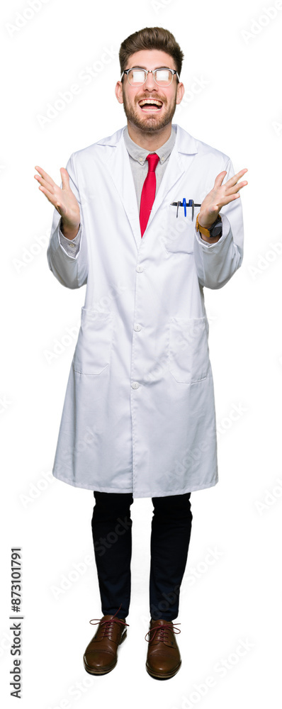 Young handsome scientist man wearing glasses celebrating crazy and amazed for success with arms raised and open eyes screaming excited. Winner concept Young handsome scientist man wearing glasses celebrating crazy and amazed for success with arms raised and open eyes screaming excited. Winner concept