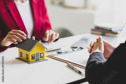 Fotografie Businesswoman discusses with real estate agent, negotiates and signs contract for purchase of house and land
