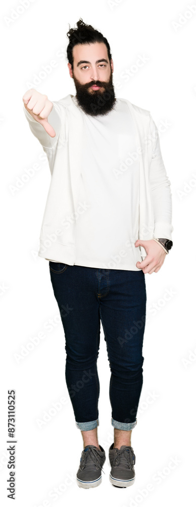 Young man with long hair and beard wearing sporty sweatshirt looking unhappy and angry showing rejection and negative with thumbs down gesture. Bad expression.