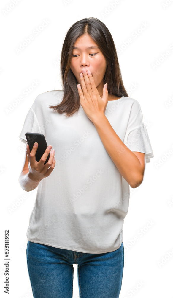 Young asian woman texting using smartphone over isolated background cover mouth with hand shocked with shame for mistake, expression of fear, scared in silence, secret concept Young asian woman texting using smartphone over isolated background cover mouth with hand shocked with shame for mistake, expression of fear, scared in silence, secret concept