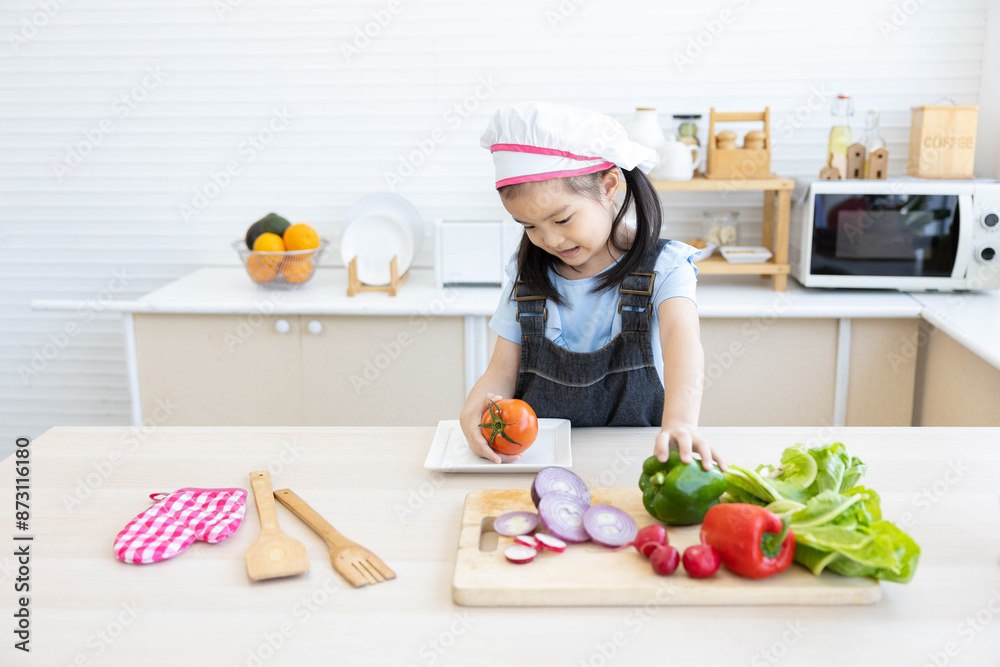 asian kid cooking and preparing vegetables meal in the kitchen asian kid cooking and preparing vegetables meal in the kitchen